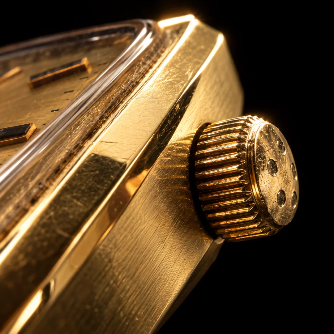 Macro detail of the crown and gold case of the Eterna Quartz watch