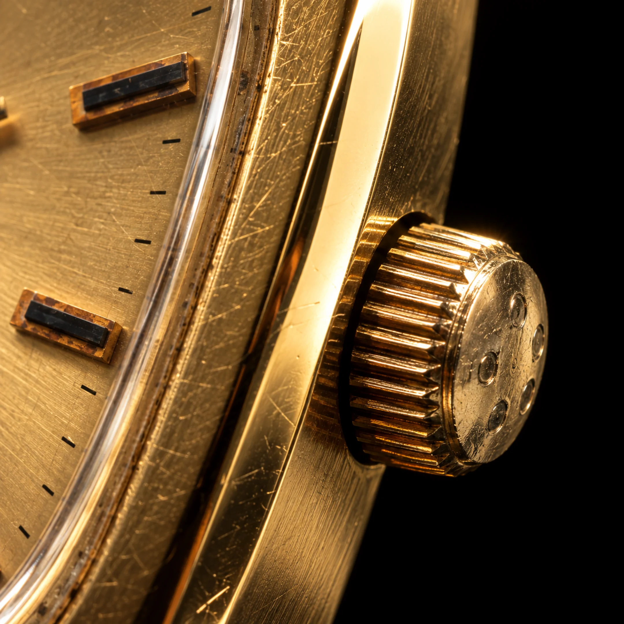 Extreme close-up of the engraved crown and patina of the Eterna Quartz watch