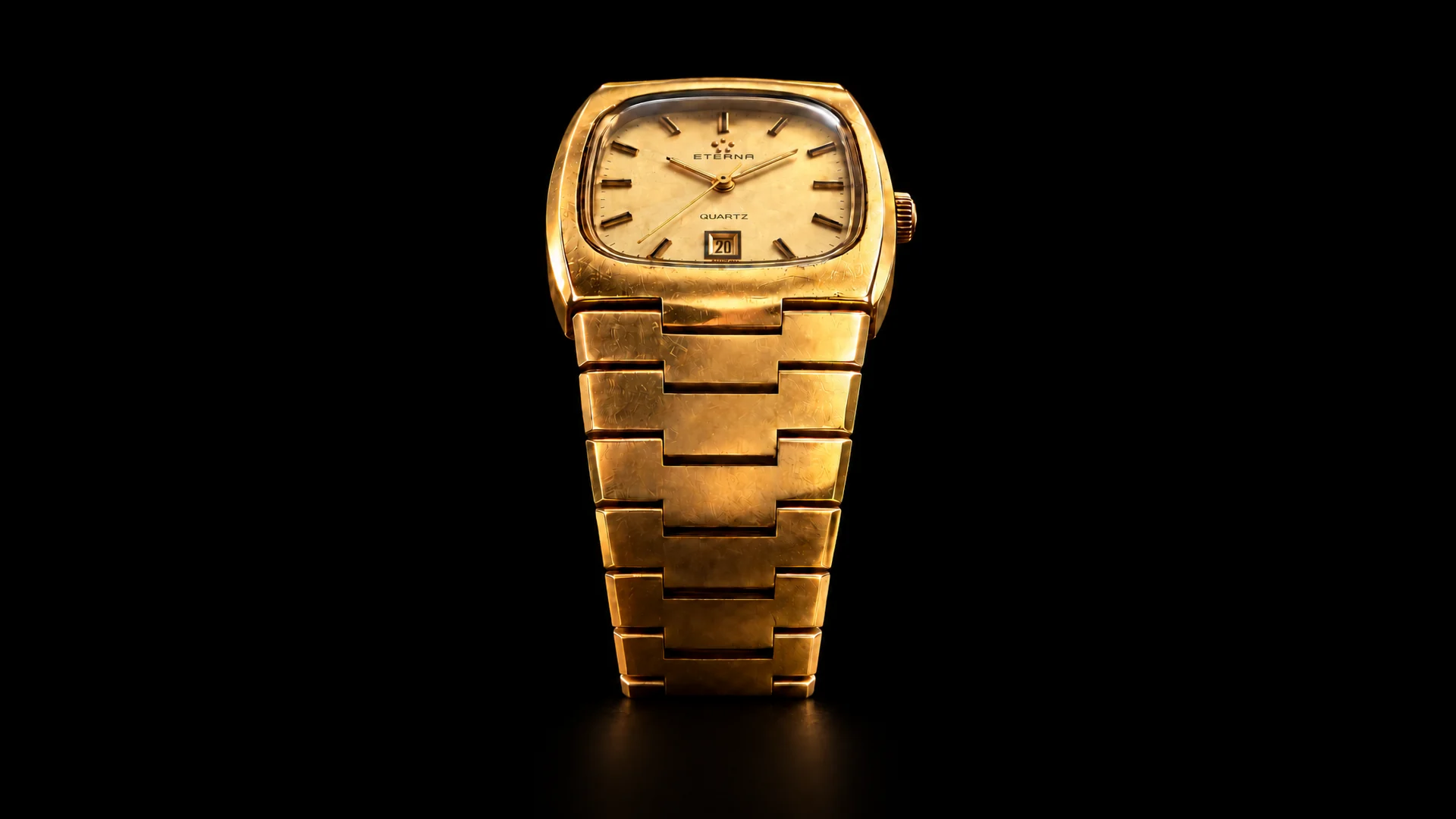 Full front view of the Eterna Quartz watch lit against a black background