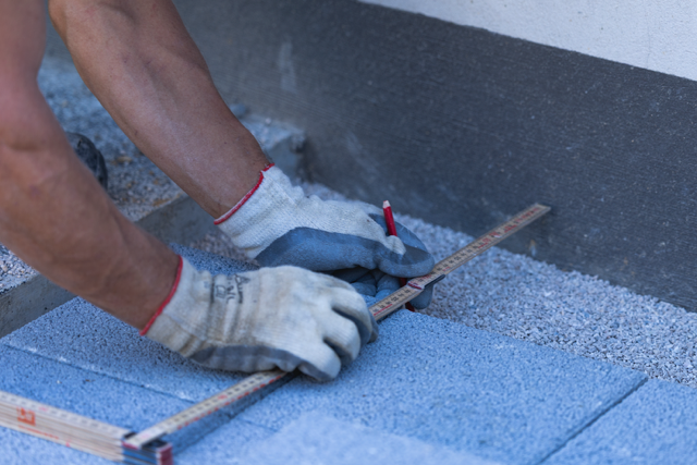 Measuring and marking a paving stone before installation