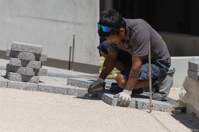 Horizon Vert worker aligning paving stones