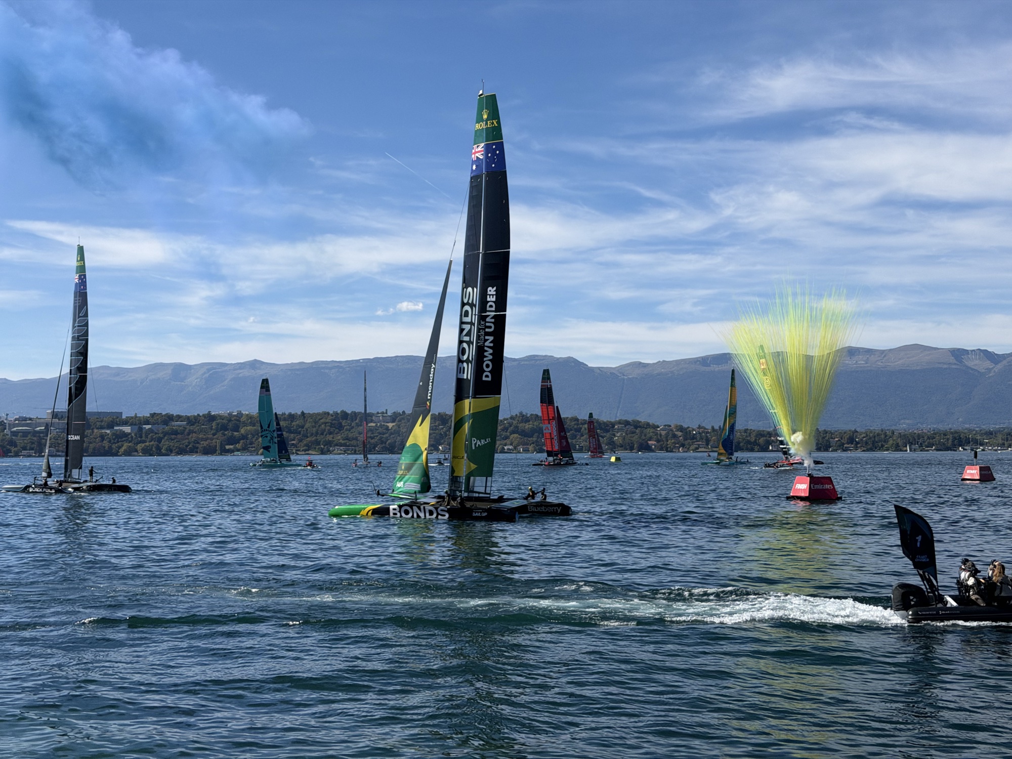 The Australian catamaran and yellow and green smoke near the finish